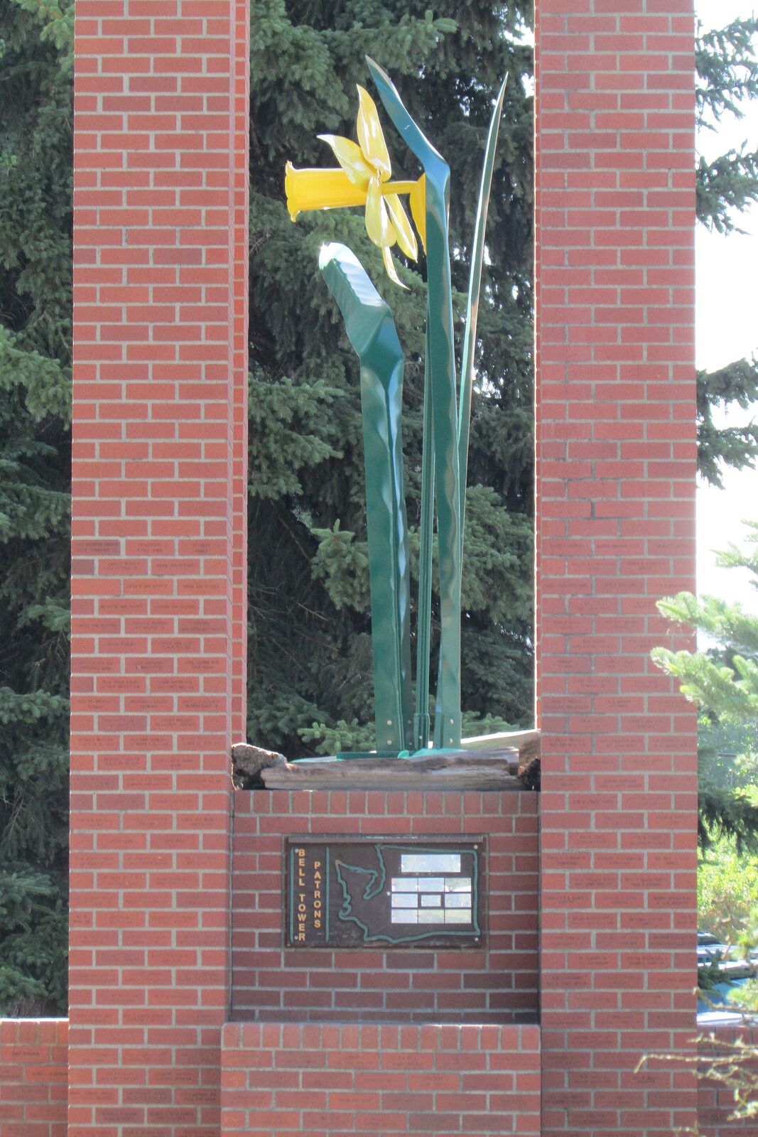 A metal daffodil sculpture on the brick bell tower